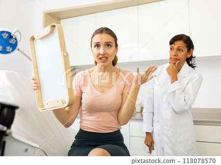 Unhappy worried woman after cosmetological procedure 118078570