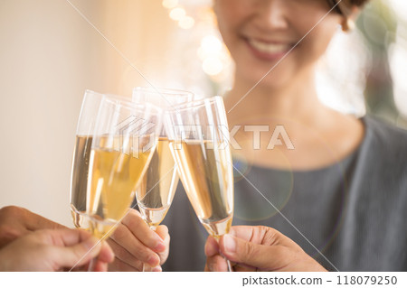 Image of a toast with champagne or wine glasses, close-up of hands without face Image of a toast with champagne or wine glasses, close-up of hands without face 118079250