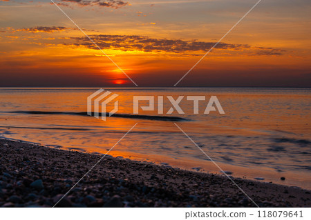 Sandy beach with pebbles of Baltic Sea on Curonian Spit at sunset. Kaliningrad region. Russia 118079641