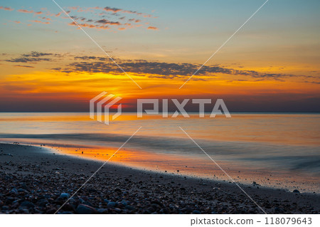 Sandy beach with pebbles of Baltic Sea on Curonian Spit at sunset. Kaliningrad region. Russia 118079643