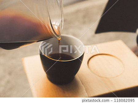 Photobash: Coffee poured from a glass container on a wooden tray 118082095