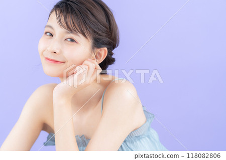 Young woman doing skin care with purple back Young woman doing skin care with purple back 118082806