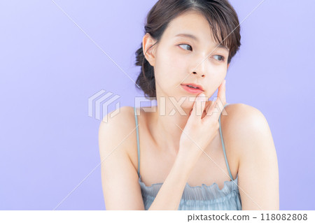 Young woman doing skin care with purple back 118082808