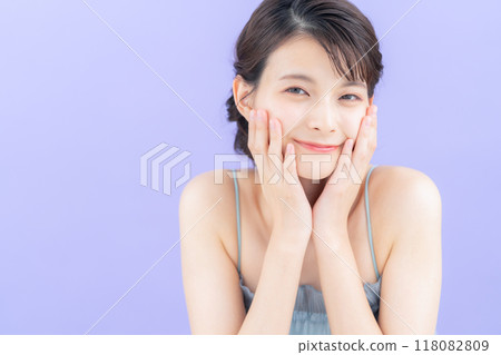 Young woman doing skin care with purple back 118082809