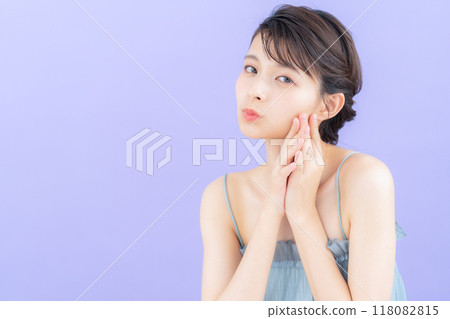 Young woman doing skin care with purple back Young woman doing skin care with purple back 118082815