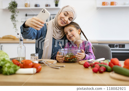 Muslim mother and daughter taking selfie with healthy salad in kitchen 118082921