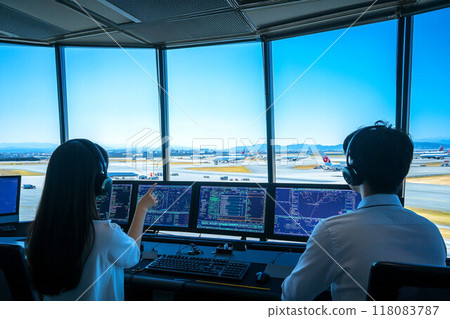 Airport control room_Air traffic controller giving instructions to aircraft_2 Airport control room_Air traffic controller giving instructions to aircraft_2 118083787