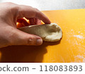 Photo of bagel dough being crushed and spread out 118083893