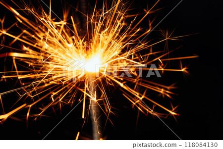 Christmas or New Year composition Bengal light. Christmas card. Close view of sparkler on black background. soft selective focus. Holiday background 118084130