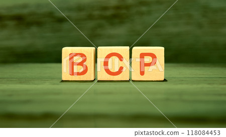 BCP Business Continuity Plan. BCP assembled from wooden cubes on a green background 118084453
