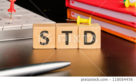 STD Sexually Transmitted Diseases. STD on wooden cubes in front of a black background 118084456
