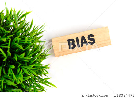 Concept of facts and biases. A word BIAS written it is laid out with wooden blocks on a white background, top view Concept of facts and biases. A word BIAS written it is laid out with wooden blocks on a white background, top view 118084475