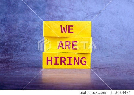 Business and Now Hiring concept. Copy space. Words WE ARE HIRING, It is made up of vertical blocks on an abstract background Business and Now Hiring concept. Copy space. Words WE ARE HIRING, It is made up of vertical blocks on an abstract background 118084485