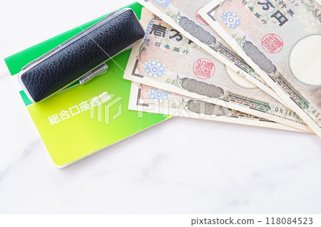 A bankbook, a seal, and a 10,000 yen note on a table A bankbook, a seal, and a 10,000 yen note on a table 118084523