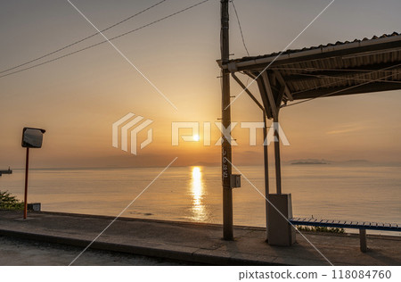 Iyo City, Ehime Prefecture: The summer solstice arrives in June. A popular tourist spot illuminated by the setting sun. Sunset over the Seto Inland Sea as seen from JR Shimonada Station. Iyo City, Ehime Prefecture: The summer solstice arrives in June. A popular tourist spot illuminated by the setting sun. Sunset over the Seto Inland Sea as seen from JR Shimonada Station. 118084760