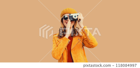 Beautiful happy woman photographer taking picture with camera, stylish creative cheerful girl 118084997