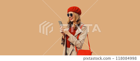 Autumn portrait of stylish happy smiling young woman with phone, beautiful girl holding smartphone 118084998