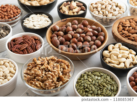 Bowls with hazelnut,walnut,pecan,almonds,peanut,sunflower and pumpkin seeds.healthy diet snack. Bowls with hazelnut,walnut,pecan,almonds,peanut,sunflower and pumpkin seeds.healthy diet snack. 118085367