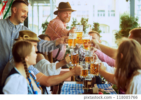 Cheers. Happy, smiling, joyful people,friends gathering at bar, clinking glasses in celebratory toast, enjoying positive meeting 118085766