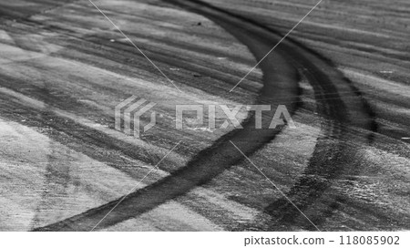 Tire track mark on asphalt tarmac road race track texture and background, Abstract background black tire tracks skid on asphalt road in racing circuit, Tire mark skid mark on asphalt road. 118085902
