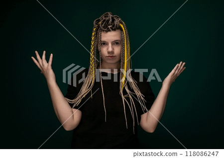 Woman With Dreadlocks in Front of Green Background 118086247