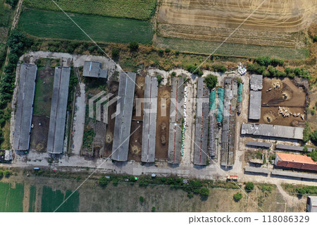 Bio farm, countryside cowshed, hangars, dairy cows, bio agricultural fields aerial Bio farm, countryside cowshed, hangars, dairy cows, bio agricultural fields aerial 118086329