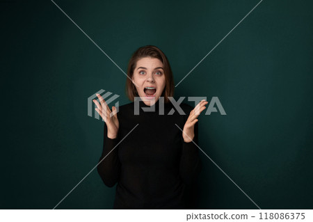 Startled Woman in Front of Green Wall 118086375