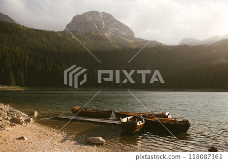 View of the Black Lake or Crno jezero , northern Montenegro. Tourist boats near wooden pier on Black lake in Durmitor national park near Zabljak, Europe View of the Black Lake or Crno jezero , northern Montenegro. Tourist boats near wooden pier on Black lake in Durmitor national park near Zabljak, Europe 118087361