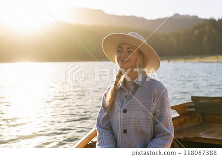 Portrait of a young woman rowing a boat on a spring day in Durmitor National Park in Montenegro 118087388