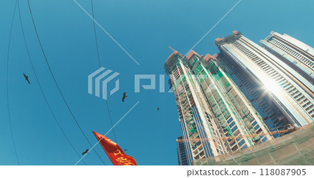 Mumbai, India. Black Kites Fly Above Slums Of Mumbai - Milvus Migrans. Bottom View On Modern Skyscrapers From Dhobi Ghat. Orange Sign Flutters In Wind In Motion. Dhobi Ghat Is Open Air Laundry. Every Mumbai, India. Black Kites Fly Above Slums Of Mumbai - Milvus Migrans. Bottom View On Modern Skyscrapers From Dhobi Ghat. Orange Sign Flutters In Wind In Motion. Dhobi Ghat Is Open Air Laundry. Every 118087905