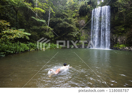 Child swimming in a waterfall in the forest Child swimming in a waterfall in the forest 118088787