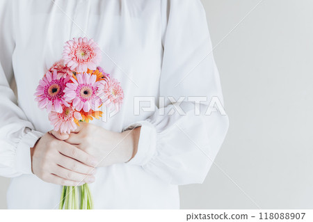 Woman with a bouquet of gerberas Woman with a bouquet of gerberas 118088907