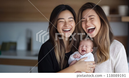 Two mothers holding their newborn baby and laughing Two mothers holding their newborn baby and laughing 118089191