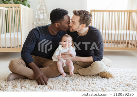 Gay dads kissing while holding their baby 118089280
