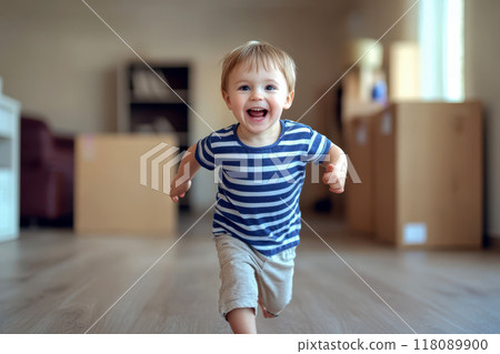 a Young little boy joyfully running in his new home or a new apartment with cardboard box on background. 118089900