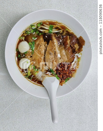 Top view of Five spice braised pork noodle in bowl on table. Top view of Five spice braised pork noodle in bowl on table. 118090636