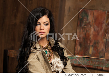 Stylish young adult woman with long wavy hair and make-up lookingat copy space  118090800