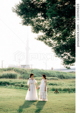 Pre-wedding photo shoot of same-sex couple walking in the park 118090828
