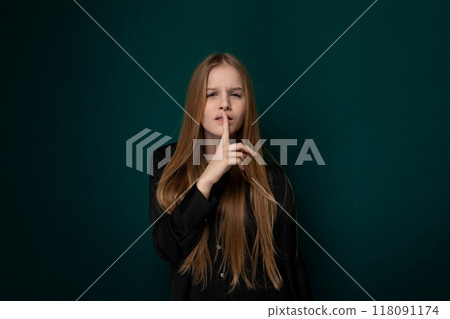Woman With Long Red Hair in Front of Green Wall 118091174