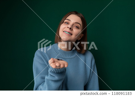 Woman in Blue Sweater Points at Something 118091183