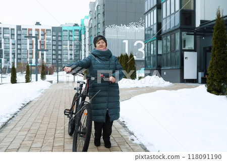 Elderly woman doing sports and riding a bicycle on the street Elderly woman doing sports and riding a bicycle on the street 118091190