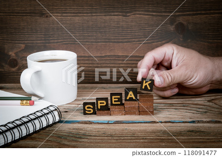 SPEAK. Old letter tiles on wooden steps, development concept SPEAK. Old letter tiles on wooden steps, development concept 118091477