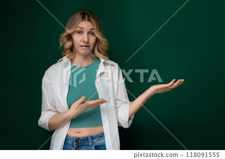 Woman Standing in Front of Green Wall With Outstretched Hands 118091555