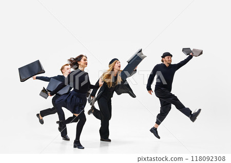 Engaged in mega sakes shopping activity. Group of people all in black outfit running with shopping bags forward isolated on white background Engaged in mega sakes shopping activity. Group of people all in black outfit running with shopping bags forward isolated on white background 118092308