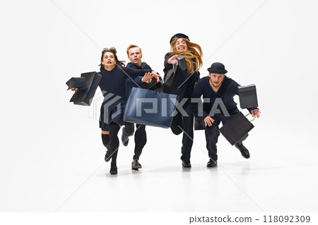 Emotional shopping activity during mega sales season, Group of people all in black outfit running with shopping bags forward Emotional shopping activity during mega sales season, Group of people all in black outfit running with shopping bags forward 118092309