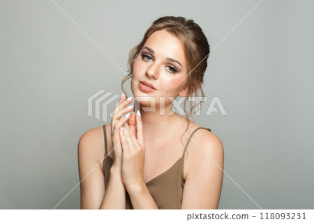 Nice female model with healthy skin, natural makeup and perfect updo hairstyle 118093231
