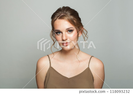Pretty adorable woman wearing green blouse. Model with make-up and updo hair, beautiful hairdo Pretty adorable woman wearing green blouse. Model with make-up and updo hair, beautiful hairdo 118093232