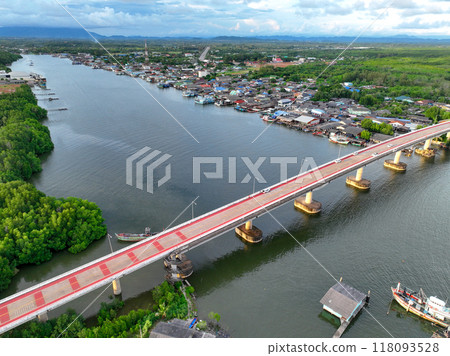 Aerial view landscape of fishing community along river, nestled within lush green mangrove forest of Pak Nam Prasae estuary in Rayong, Thailand. Ecotourism and sustainable travel. Net zero tourism. 118093528