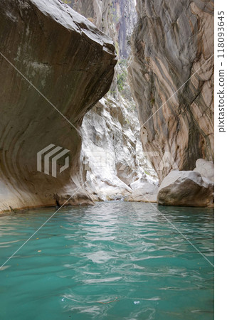 A narrow canyon with a river running through it A narrow canyon with a river running through it 118093645