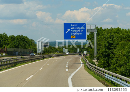Traveling along the scenic highway towards Aalen and Nordlingen in sunny weather with expansive greenery lining the road 118095263